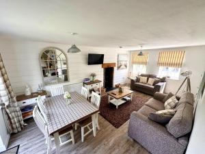 a living room with a couch and a table at Gingerbread Cottage in Filey