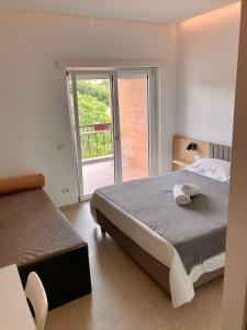 a bedroom with a bed and a sliding glass door at FAZIO ROOMS Roma in Rome