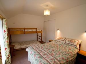 a bedroom with a bed and a bunk bed at Chyandaunce in Penzance