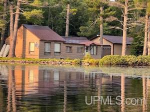 a house on the shore of a body of water at Sandy Lake Retreat in Toivola