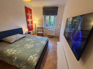 a small bedroom with a bed and a picture on the wall at City Apartment 8 JOSEF 3rd Floor 44 m2 in Graz
