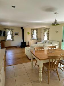 a living room with a couch and a table at 2 Bed House - Sleeps 4 - Fishing - Parking - Patio in Abergavenny