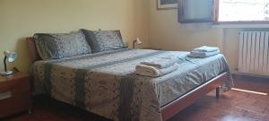 a bedroom with a bed with towels on it at Appartamento a Castellarano Manzoni house in Castellarano