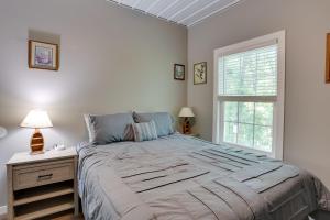 a white bedroom with a large bed and a window at Boat Ramp Access Dog-Friendly Kentucky Lake Gem in New Johnsonville
