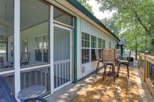 a porch of a house with chairs and a table at Boat Ramp Access Dog-Friendly Kentucky Lake Gem in New Johnsonville
