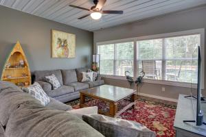 a living room with a couch and a table at Boat Ramp Access Dog-Friendly Kentucky Lake Gem in New Johnsonville +16 photos