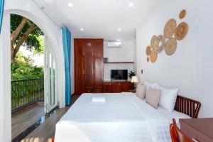 a bedroom with a white bed and a balcony at Yubi Villa Private Swimming Pool 100m2 - Super Vip in Vung Tau +55 photos