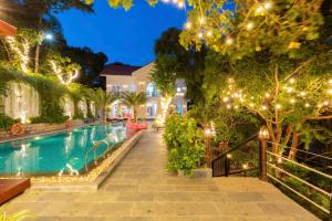a swimming pool in a yard with christmas lights at Yubi Villa Private Swimming Pool 100m2 - Super Vip in Vung Tau