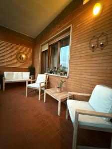 a porch with chairs and a table and a window at Vatican luxury - private parking free - meospiti luxury in Rome +38 photos