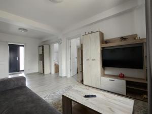 a living room with a large flat screen tv at Kve Apartment in Iaşi