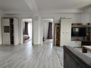 a large living room with white walls and wooden floors at Kve Apartment in Iaşi