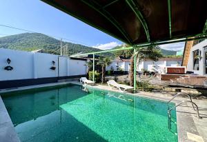 a swimming pool with a view of a mountain at NatureNest A-Frame Cabin in Gabala