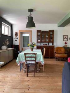 a living room with a table with flowers on it at Casa Rossa in Montecassiano