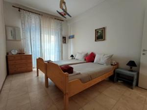 a bedroom with a large bed and a window at Sea view in Nea Peramos