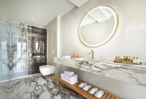a bathroom with a sink and a toilet and a mirror at Boutique Hotel Mauro in Poreč