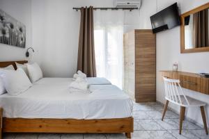 Postel nebo postele na pokoji v ubytování Galini Apartments