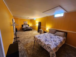 a bedroom with yellow walls and a bed and a window at Trailside Furnished Apartment 