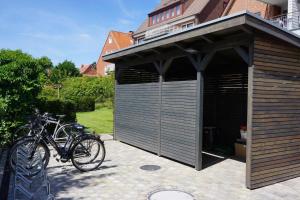 a garage with two bikes parked in it at Stranddüne im Achterhus in Juist