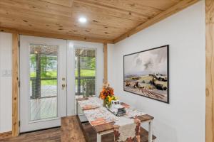 a dining room with a table with flowers on it at Creekside Retreat Arcade Fire Pit in Pigeon Forge