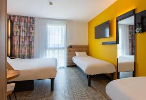 Postel nebo postele na pokoji v ubytování B&B HOTEL Orléans Saran