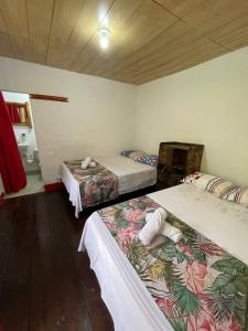 a room with two beds and a sink in it at Ecohotel Bellavista Pance in Cali