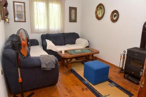 a living room with a couch and a table at Rest House Tara in Mojkovac