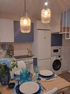 a kitchen with a table with plates and glasses on it at O Pescador in Noya