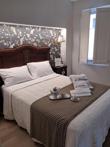 a bedroom with a large white bed with a tray on it at O Pescador in Noya