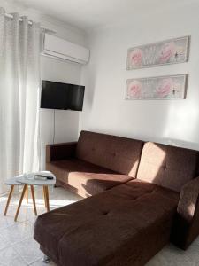 a living room with a couch and a table at Isolde Apartment in Kallithea Halkidikis