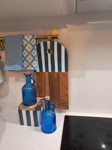 two blue vases sitting on top of a counter at O Pescador in Noya