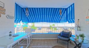 a large window with a desk and a chair in a room at Seaside Apartment Steps to Breathtaking Sunrise in Luquillo