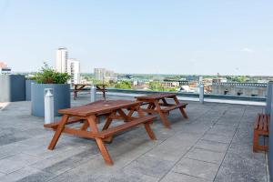 a group of picnic tables on top of a roof at Ensuite Single Room in Central Coventry in Coventry
