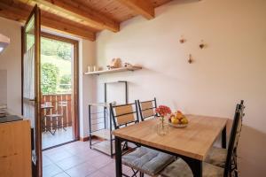 a kitchen and dining room with a wooden table and chairs at APARTHOTEL STREMBO in Strembo