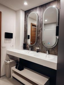 a bathroom with a sink and a mirror at Central Hostel Lesce-Bled in Lesce