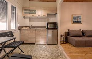 a small kitchen and living room with a couch at Preveza Alex Apartments in Preveza