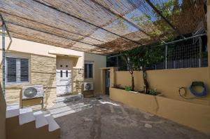 a patio with a pergola on the side of a house at Alex Apartments in Preveza