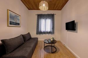 a living room with a couch and a table at Alex Apartments in Preveza