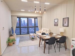 a living room with a table and a couch at Homestay at Trion KL in Kuala Lumpur