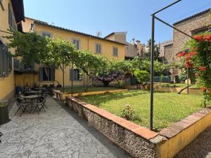 a courtyard of a building with a table and chairs at NEW GENERATION HOSTEL Florence in Florence