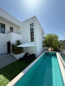 a villa with a swimming pool and a house at Villa Simon2 in Veliko Brdo