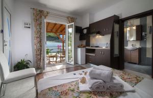 a room with a bed and a kitchen with a view at Caretta Village in Toroni