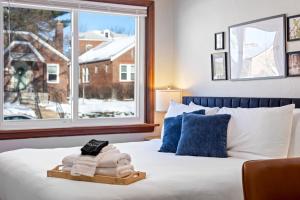 a bedroom with a bed with a window and towels at The Urban Nest – Your St. Louis City Retreat! in Saint Louis