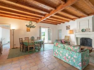 a living room with a table and a couch at Holiday Home Château de Taupignac by Interhome in Breuillet