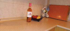 a bottle of wine sitting on top of a counter at Sea view in Nea Peramos