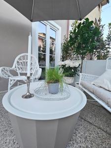 a white coffee table with a candle on a patio at The Little Guest house in Lucca +13 photos