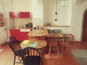 a kitchen with a wooden table and chairs and a table and a kitchen at Bergmanns Lieblingsplatz in Freiberg
