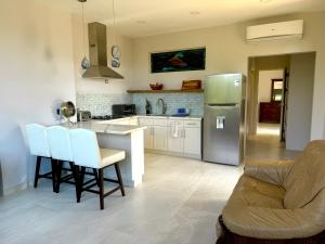 a kitchen with a refrigerator and a table and chairs at Casa Dorada 55 Studio in Marbella