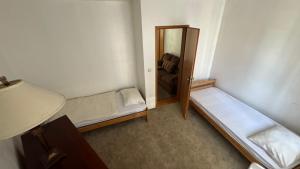 a small room with two beds and a mirror at Private house - outdoor barbecue in Sarajevo
