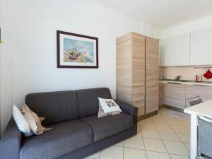 ein Wohnzimmer mit Sofa und eine Küche in der Unterkunft Apartment Happiness by Interhome in Loano + 18 Fotos