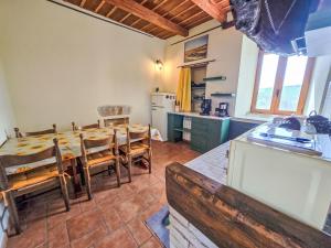 a kitchen and dining room with a table and chairs at Holiday Home Leone D'Oro by Interhome in Casa San Giovanni +27 photos
